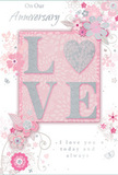 In this image, a delicately designed anniversary card celebrates enduring romance with a palette and style that would suit a quiet evening in Aldgate, just beyond the bustle of the City. The card blends soft pastel pinks with silvery greys and gentle whites, creating a feeling of treasured intimacy. At the centre sits the word LOVE, formed in raised, velvety glitter that gives each letter a softly shimmering outline. The letter O is replaced by a silver heart, textured so that it seems to glow a little more brightly than the surrounding script, becoming the emotional focal point of the card. Around this word, a halo of blossoms in blush, mauve, and pale ivory unfurls with a watercolor-like softness. The petals, leaves, and fine stems flow in curved lines, giving the sense that the flowers are lightly dancing in a breeze winding its way from Aldgate down toward the river. Tiny flourishes - curling vines, trailing petals, and discreet butterfly shapes - weave through the design, adding a touch of motion and whimsy reminiscent of an English spring garden. Above and below the floral motif, the phrases On Our Anniversary and I love you today and always appear in understated, graceful script. The lettering feels carefully placed, as considered as the final stem added to a bouquet before it leaves a local Aldgate florist's hands. The overall composition is understated yet expressive, combining soft colour, subtle sparkle, and flowing lines to create a keepsake that honours a shared journey with warmth, tenderness, and a sense of quiet celebration.